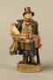 Terracotta figurine of a Jewish ribbon peddler with a basket of colorful cloth