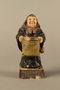Ceramic match holder of a Jew holding out a bag