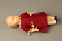 Plastic doll with a burgundy dress brought with a young Austrian Jewish refugee