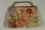 Floral tapestry purse saved by a hidden child