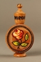 Wooden perfume bottle holder with recessed designs owned by a Yugoslavian family