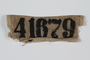 Stained white cloth patch with prisoner number 41679 worn in Buchenwald concentration camp