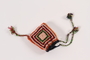 Doll's colorful crocheted tassel hat given to a young girl after her release from Theresienstadt