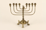 Brass Hanukkah menorah with fish shaped feet used by a Jewish refugee family