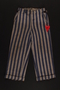 Concentration camp uniform pants with red triangle patch worn by Polish Jewish inmate