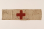 White armband with a red cross worn by a concentration camp inmate
