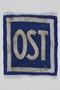Forced labor badge, blue field with OST in white letters, to identify a forced laborer from the Soviet Union