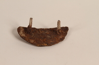 1989.308.24 front
Rusted heel plate with a screw and nail recovered from Chelmno killing center

Click to enlarge