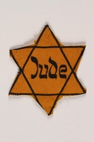 1996.23.73 front
Yellow cloth Star of David badge with the word Jude

Click to enlarge