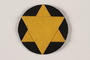 Star of David badge with a yellow star on a black circle worn by a Jewish Romanian woman