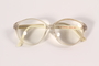 Clear and white plastic eyeglasses worn by a Jewish emigrant