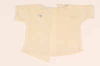 2010.337.3 front
Infant’s open back white blouse with a light blue monogram made in DP camp

Click to enlarge