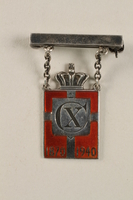 2010.417.1 front
Kingmark silver and red enamel pin with chains on a pinbar commemorating the 70th birthday in 1940 of King Christian X of Denmark

Click to enlarge