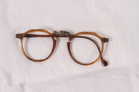 2010.494.2 a front
Plastic eyeglass frames, temple and lenses worn by a Jewish concentration camp inmate

Click to enlarge