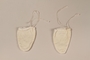 White drawstring hand coverings worn by a Jewish infant living in hiding