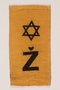 Rectangular yellow badge with Star of David and Ž kept by hidden child