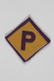 Forced labor badge, yellow with a purple P, worn by a Polish Jewish woman in hiding as a Catholic