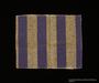 Cloth square cut from a blue and gray striped concentration camp inmate uniform