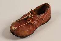 1998.41.1 front
Toddler's red leather shoe worn by Alain Markon in Vichy France

Click to enlarge