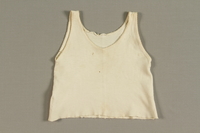 1998.41.3 front
Toddler's white knit undershirt worn by a Jewish refugee from German occupied France

Click to enlarge