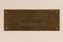 Small brass sign from the family capmaking business brought to the US by a Jewish refugee from Vienna