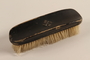 Hairbrush with a metal swastika