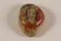 Small rock with a painted portrait of a dark haired woman killed in a concentration camp