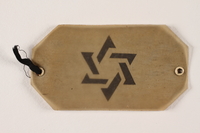 2004.706.4 front
Plastic covered paper armband with a cut out Star of David worn in the Boryslaw ghetto

Click to enlarge