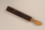 Wood mounted razor strop used by a barber in a concentration camp