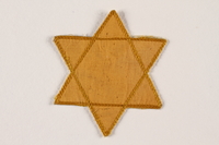 2007.45.8 front
Yellow cloth Star of David badge with a blank center

Click to enlarge