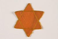 2007.45.9 front
Yellow cloth Star of David badge with a blank center

Click to enlarge