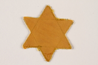 2007.45.10 front
Yellow cloth Star of David badge with a blank center

Click to enlarge