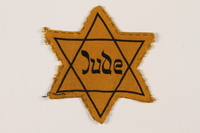 2007.45.14 front
Yellow cloth Star of David badge with Jude printed in the center

Click to enlarge