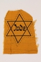 Unused yellow cloth Star of David badge with Jude printed in the center