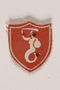 Red shield shaped badge with the Mermaid of Warsaw owned by a Polish soldier