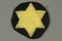 Circular patch with a yellow Star of David worn by a Jewish Romanian woman