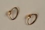 Gold hoop earrings worn by a hidden child in Poland