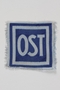 Unused forced labor badge, blue field with OST in white letters, to identify a forced laborer from the Soviet Union