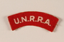 Embroidered, red UNRRA worn by a former concentration camp inmate and DP relief worker