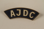 Blue AJDC pin worn by a former concentration camp inmate and refugee aid worker