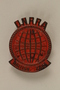 Globe-shaped UNRRA pin worn by a former concentration camp inmate and refugee aid worker