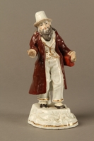 2016.184.11 front
White porcelain figurine of a Jewish money changer in a gold dotted vest

Click to enlarge