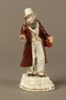 White porcelain figurine of a Jewish money changer in a gold dotted vest