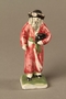 Small ceramic figure of a Jewish man in a long red coat