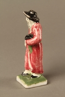 2016.184.30 left side
Small ceramic figure of a Jewish man in a long red coat

Click to enlarge