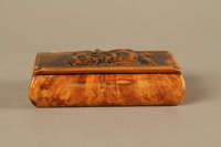 2016.184.42 front
Wood snuff box with a carving of three Jewish hareskin dealers

Click to enlarge