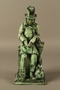 Green ceramic figurine of a Jewish peddler counting his money