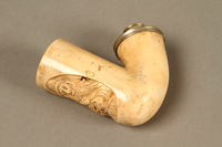 2016.184.117_a 3/4 view
Meerschaum pipe bowl with a carved image of a Jewish man holding a pig

Click to enlarge