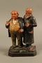 Ceramic figure group of a poor Jew with an unhappy merchant