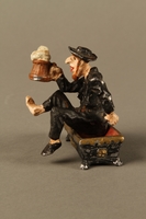 2016.184.134 _a-b left side
Painted metal figurine of a drunken Jewish man in a trough

Click to enlarge